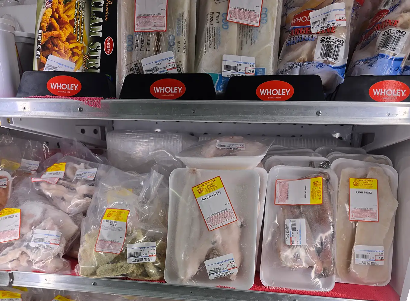 Variety of Frozen Seafood such as clam strips, catfish files, Alaskan pollock, breaded catfish nuggets - midstate meat company springfield il
